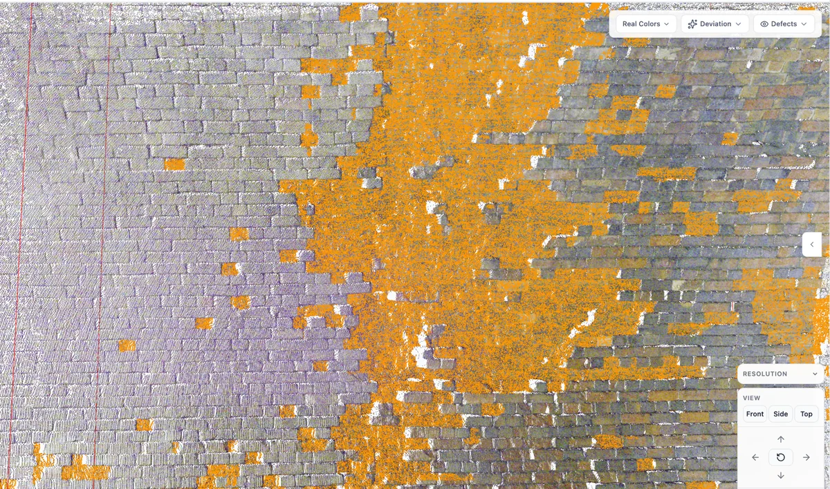 Close-up of a masonry tunnel lining point cloud with regions of spalling and mortar loss segmented in orange